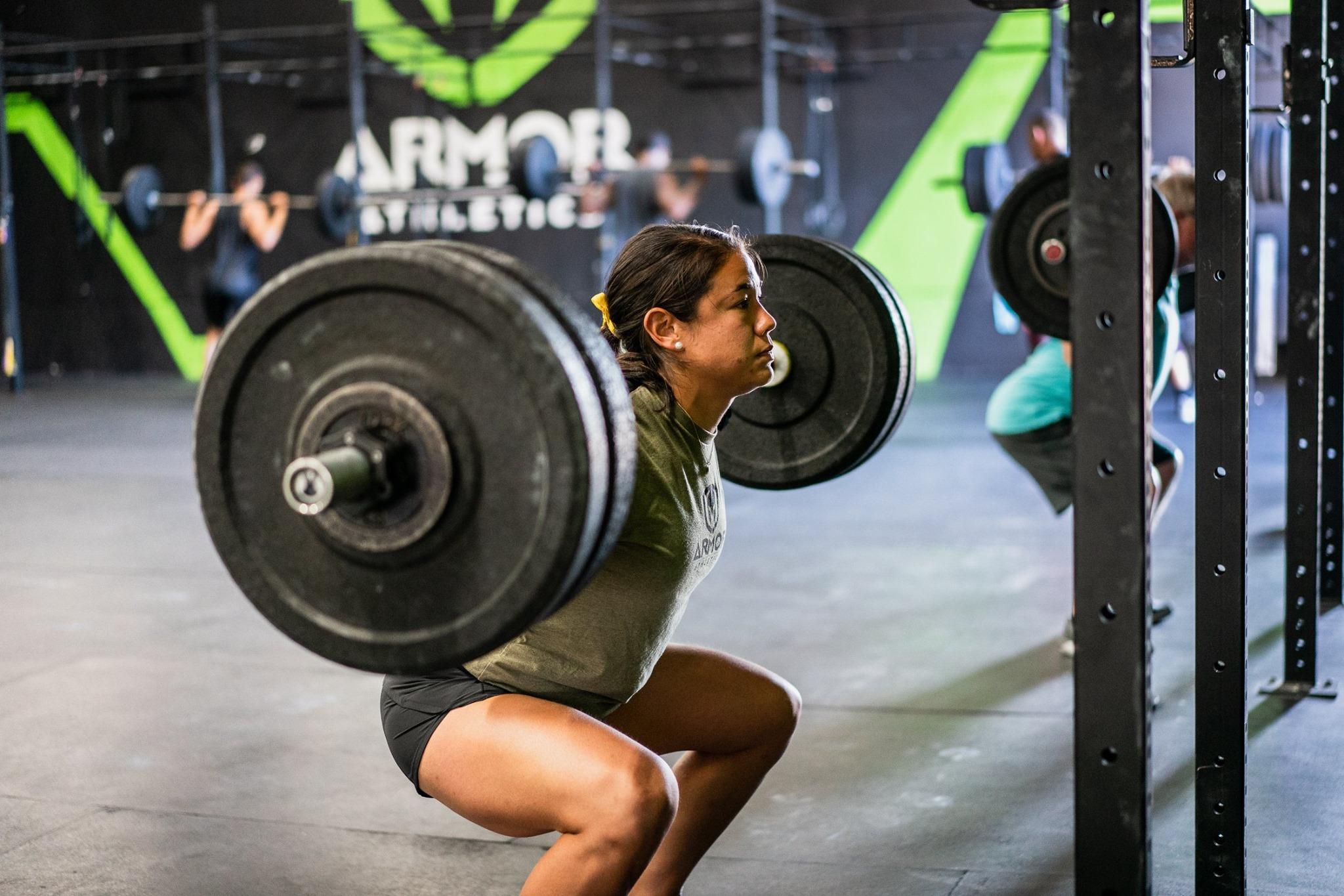 An Armor Athletics coach training on the gym floor